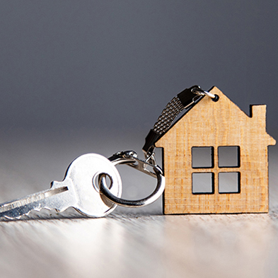 house keychain with key on table