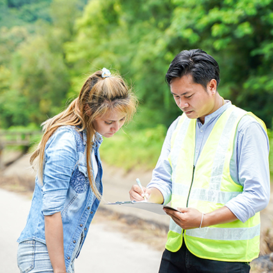 two people looking at a clipboard