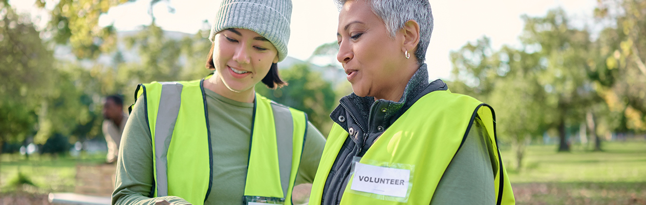 two women volunteers looking at a clipboard