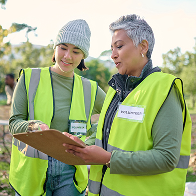 two women volunteers looking at a clipboard